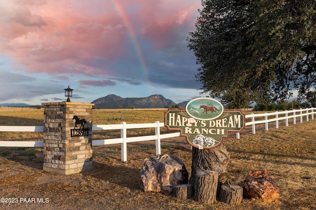 community / neighborhood sign with a mountain view and a rural view