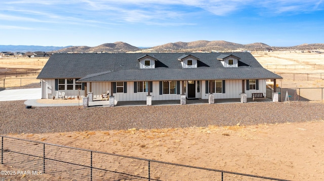 view of front of property with a porch and a mountain view