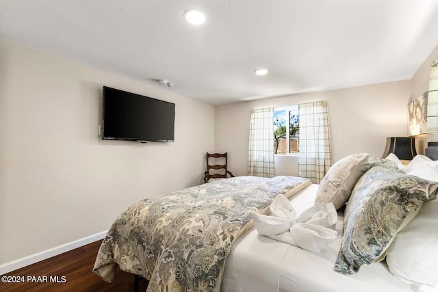 bedroom with dark hardwood / wood-style flooring