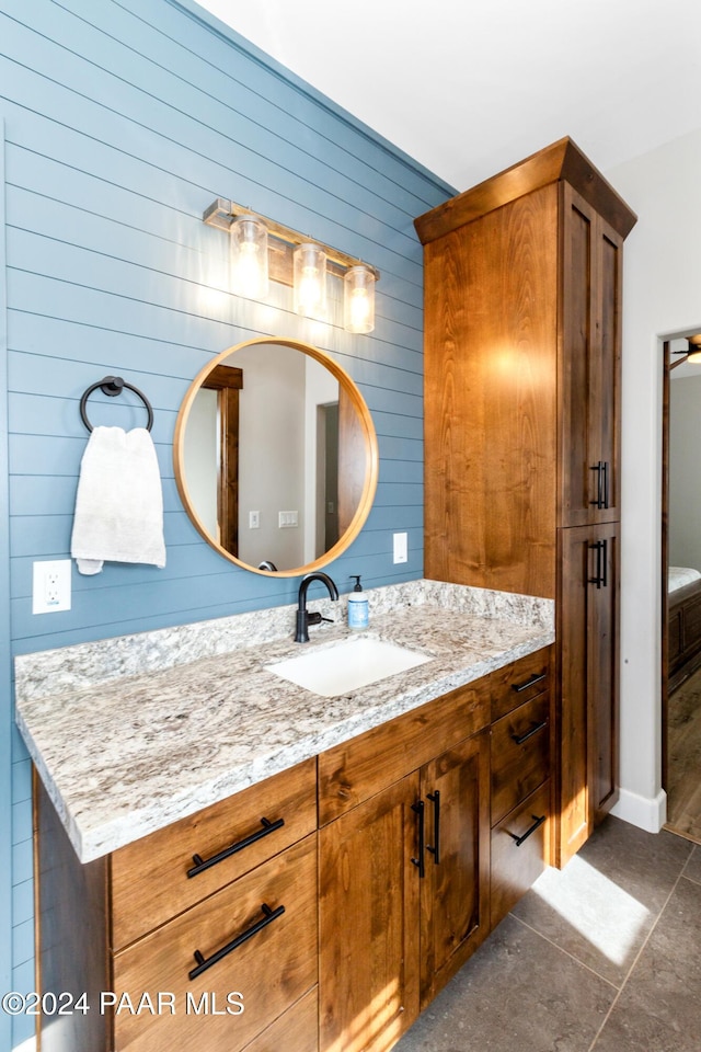 bathroom with wood walls and vanity