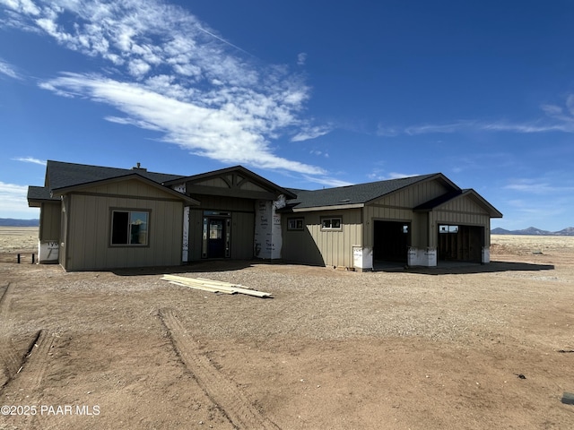 view of front of house with an attached garage, board and batten siding, and driveway