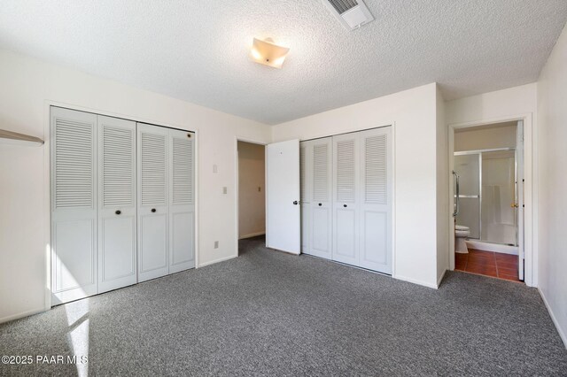 401 Valley Pl, Prescott, AZ 86301 - unfurnished bedroom featuring carpet floors, a textured ceiling, visible vents, and two closets