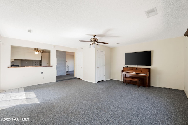 401 Valley Pl, Prescott, AZ 86301 - unfurnished living room featuring a textured ceiling, carpet flooring, ceiling fan, and visible vents