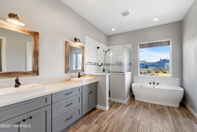 9550 N Manger Rd, Prescott Valley, AZ 86314 - full bath featuring a walk in shower, double vanity, a soaking tub, wood finished floors, and recessed lighting