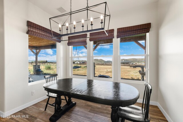 9550 N Manger Rd, Prescott Valley, AZ 86314 - dining room with plenty of natural light, wood finished floors, and a chandelier
