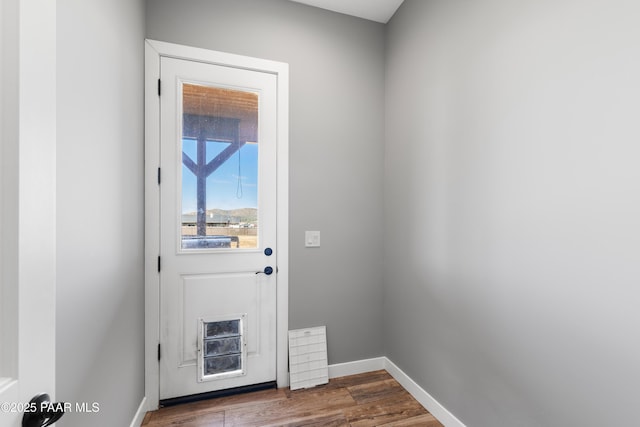 9550 N Manger Rd, Prescott Valley, AZ 86314 - doorway to outside featuring dark wood-style floors and baseboards