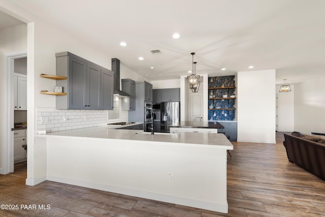 9550 N Manger Rd, Prescott Valley, AZ 86314 - kitchen with wall chimney exhaust hood, open shelves, appliances with stainless steel finishes, gray cabinetry, and a peninsula