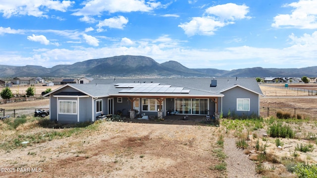 9550 N Manger Rd, Prescott Valley, AZ 86314 - rear view of house featuring a mountain view, roof mounted solar panels, and a sunroom