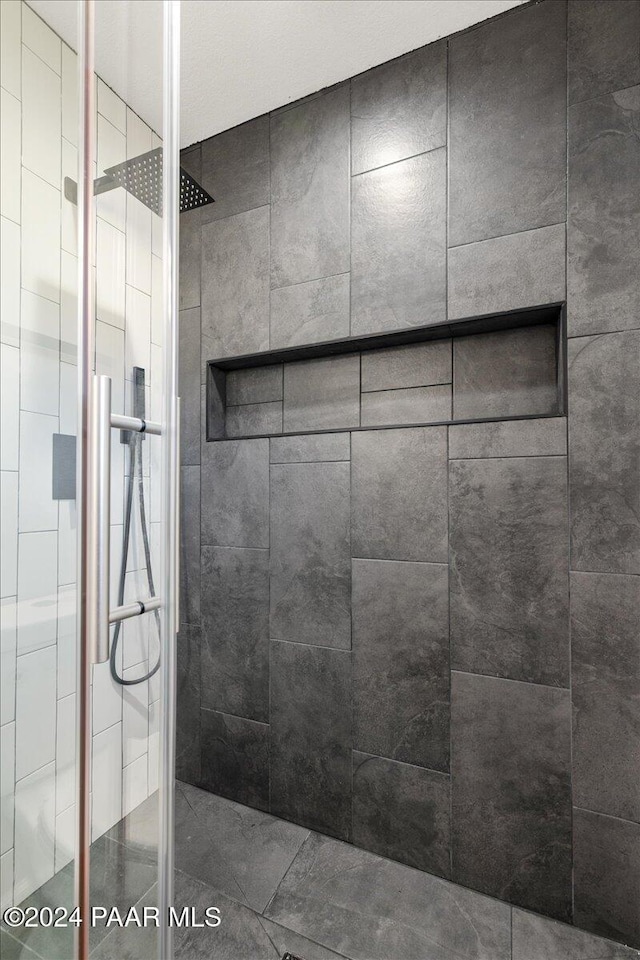 bathroom with tiled shower