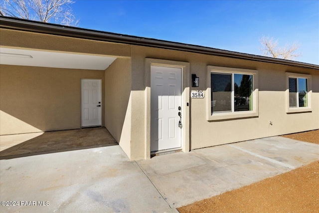 doorway to property with a patio area