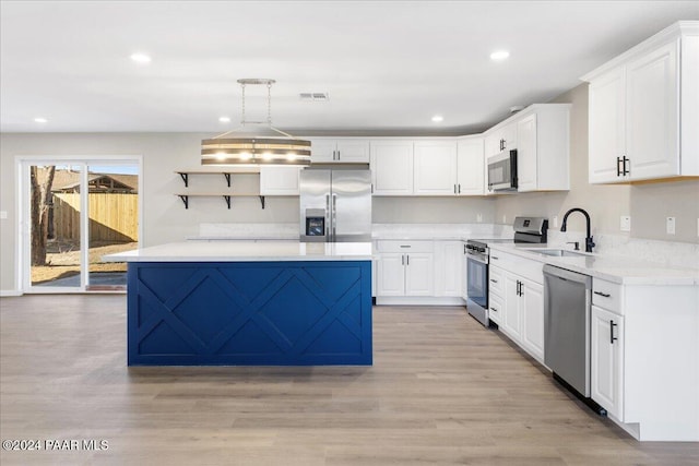 kitchen with white cabinetry, sink, stainless steel appliances, light hardwood / wood-style flooring, and pendant lighting