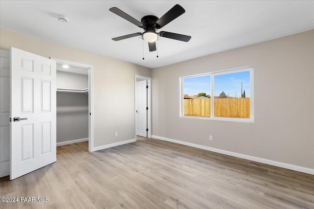 unfurnished bedroom with a closet, light hardwood / wood-style flooring, and ceiling fan