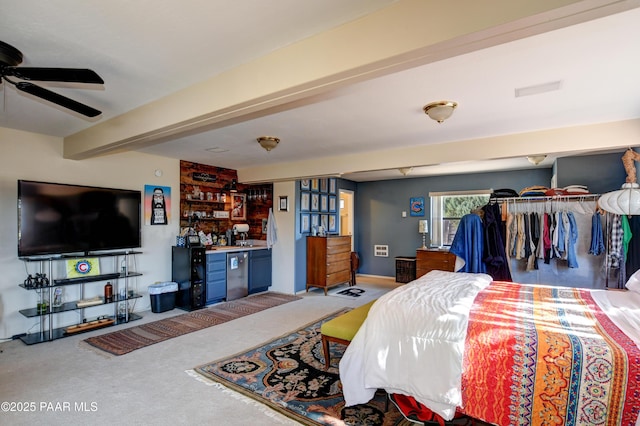 carpeted bedroom with fridge, bar area, and beam ceiling