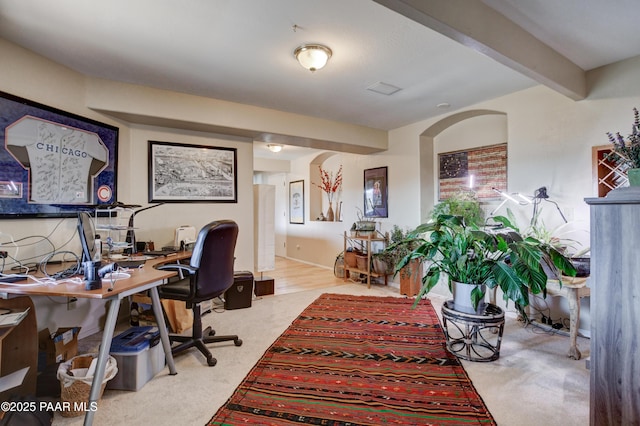 office space with beamed ceiling and carpet