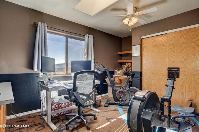 office with ceiling fan and a skylight