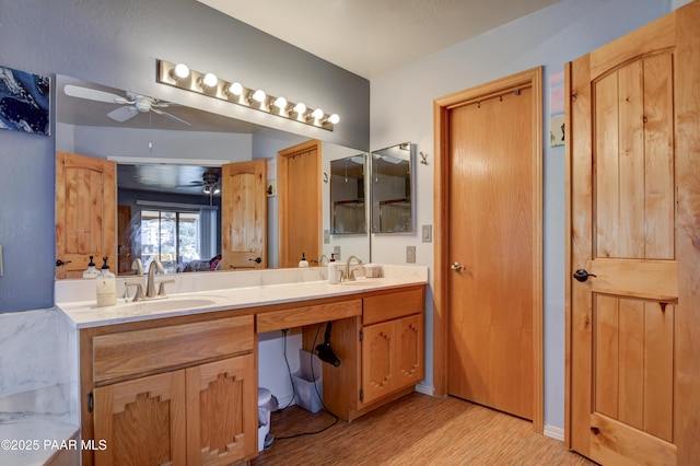 bathroom featuring vanity, hardwood / wood-style floors, and ceiling fan