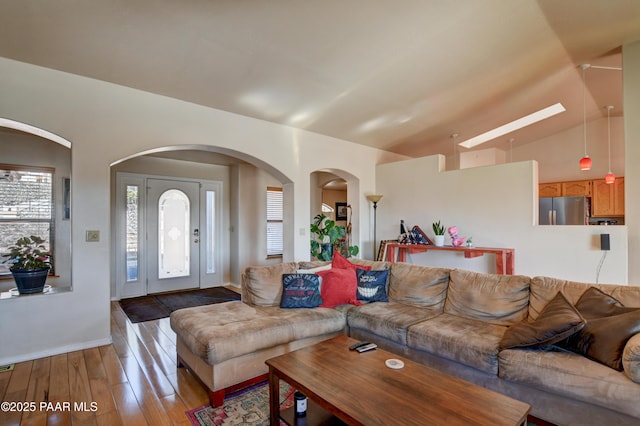 living room with lofted ceiling and wood-type flooring