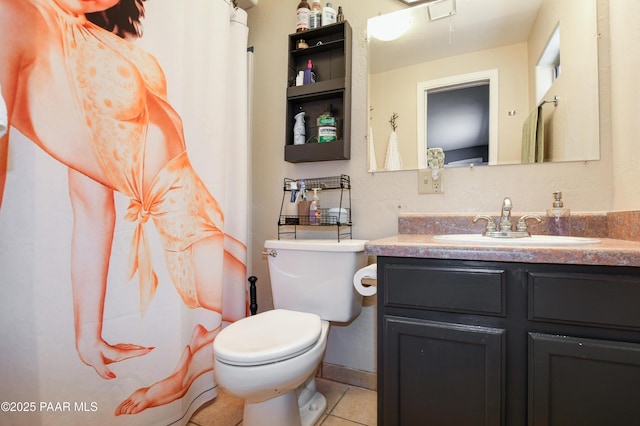 bathroom featuring vanity, tile patterned flooring, and toilet