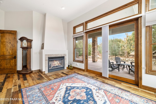 interior space with a tiled fireplace and hardwood / wood-style floors