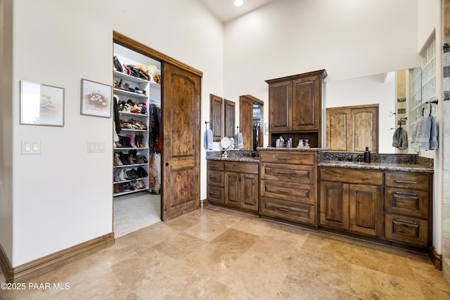 bathroom featuring vanity and a towering ceiling