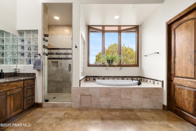 bathroom with vanity and separate shower and tub