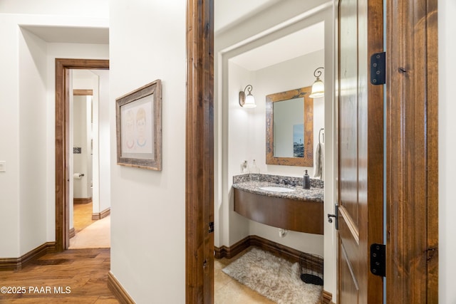 bathroom with hardwood / wood-style floors and sink