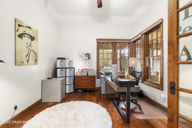 office space with dark wood-type flooring and ceiling fan