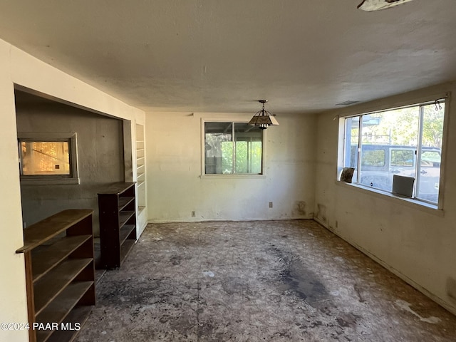 unfurnished bedroom featuring multiple windows