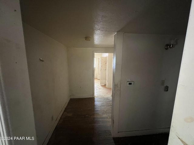 corridor with dark hardwood / wood-style flooring