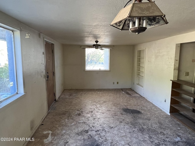 spare room with ceiling fan and a textured ceiling