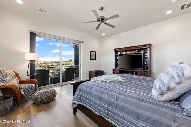 bedroom with recessed lighting, wood finished floors, visible vents, and access to exterior