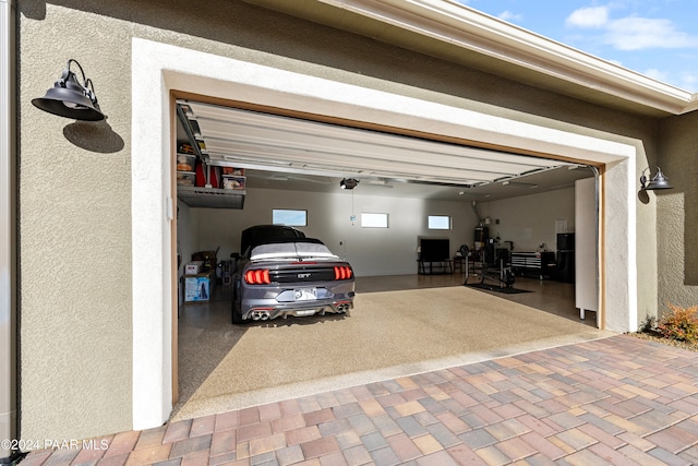 garage featuring decorative driveway