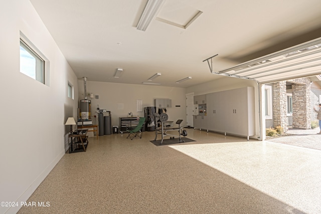 garage with water heater and baseboards