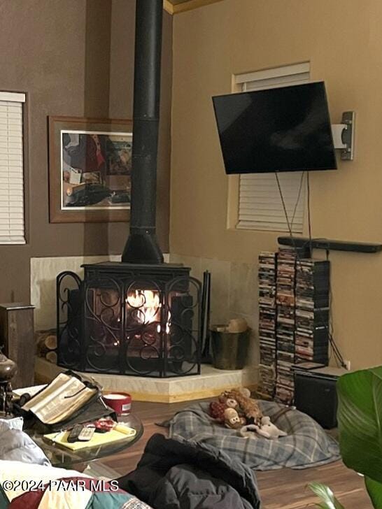 interior space with hardwood / wood-style flooring and a wood stove