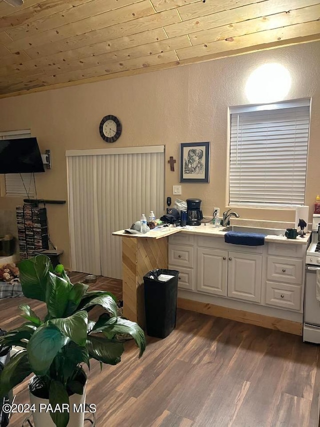 kitchen with white cabinetry, sink, dark hardwood / wood-style flooring, white gas stove, and wooden ceiling