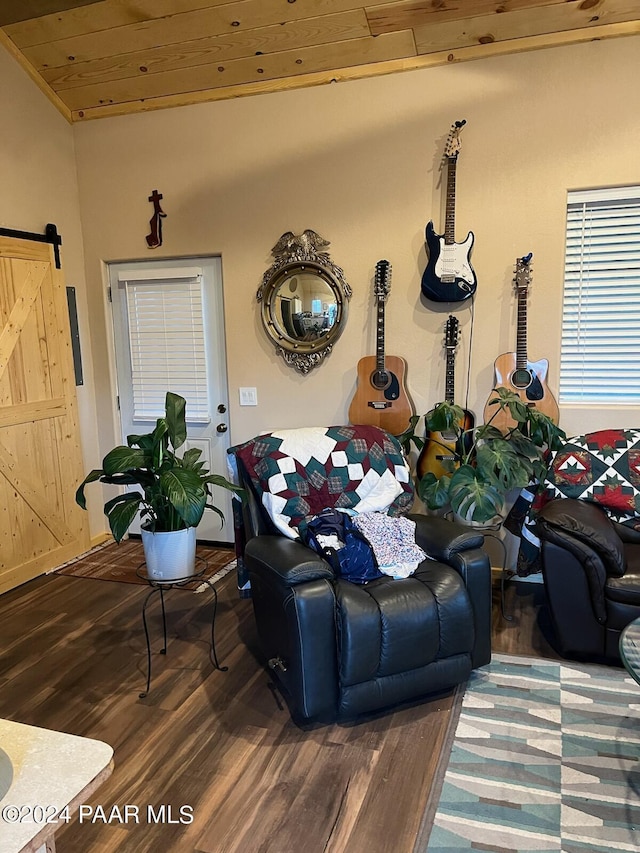 living room with lofted ceiling, wood ceiling, dark wood-type flooring, and a barn door