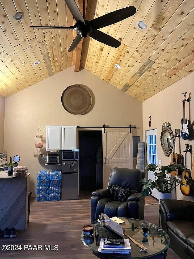 living room with vaulted ceiling with beams, wood ceiling, dark hardwood / wood-style floors, ceiling fan, and a barn door