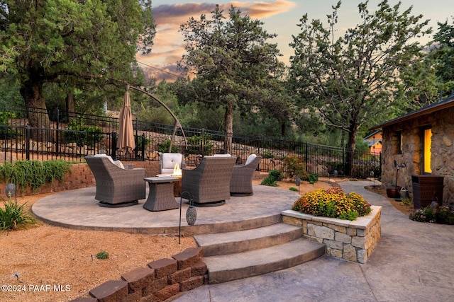 patio terrace at dusk featuring an outdoor living space