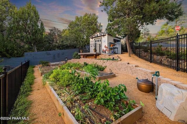 yard at dusk featuring an outdoor structure