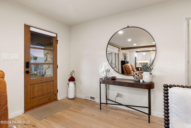 foyer entrance with light hardwood / wood-style flooring and ceiling fan