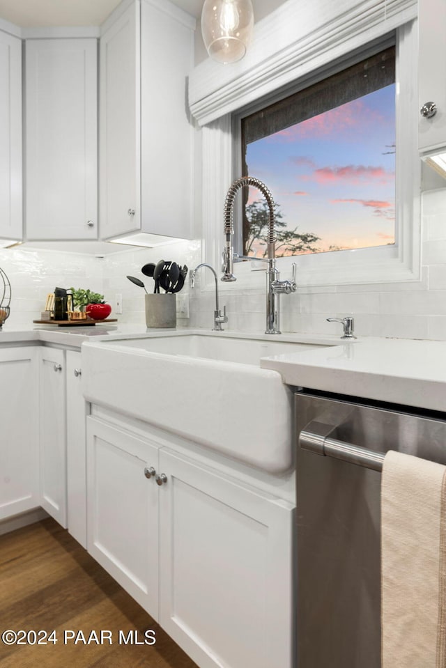 kitchen featuring white cabinets, dishwasher, dark hardwood / wood-style floors, and decorative backsplash