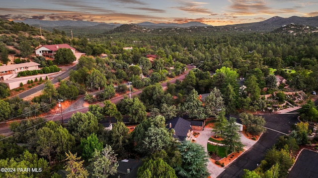 aerial view at dusk featuring a mountain view