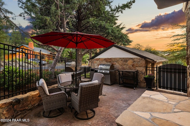 patio terrace at dusk with a grill