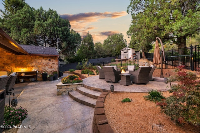 patio terrace at dusk featuring an outdoor hangout area