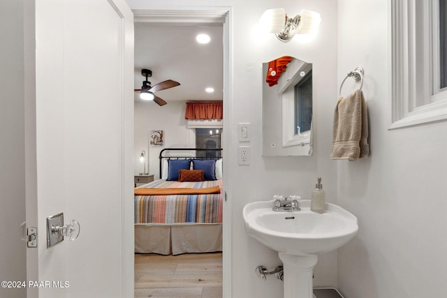 bathroom featuring wood-type flooring, ceiling fan, and sink