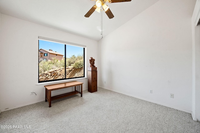 unfurnished room featuring vaulted ceiling, carpet, a ceiling fan, and baseboards