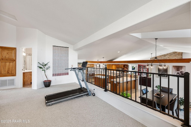 workout area featuring a notable chandelier, lofted ceiling, visible vents, and carpet floors
