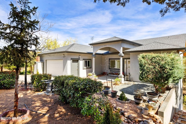 527 Eastwood Dr, Prescott, AZ 86303 - back of house featuring a garage, roof with shingles, and stucco siding