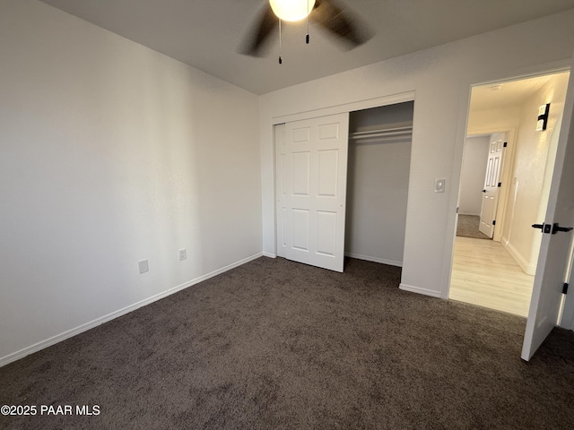 unfurnished bedroom with a closet, a ceiling fan, baseboards, and carpet floors