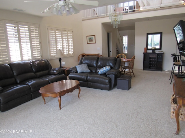 living room with ceiling fan, plenty of natural light, and carpet